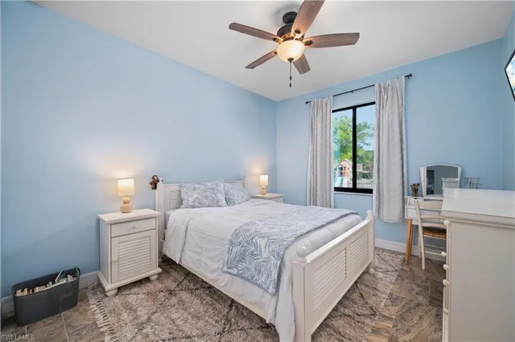 Bedroom with stone finish flooring and ceiling fan