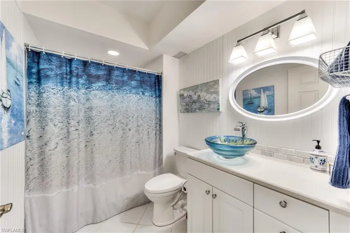 GUEST BATHROOM HAS BEEN UPDATED WITH DESIGNER SINKS AND QUARTZ