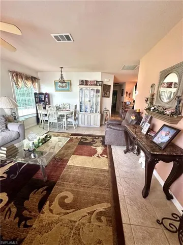 Living area featuring tile patterned flooring and baseboards