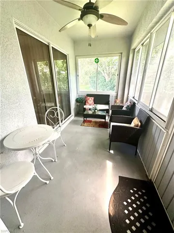 Sunroom with a ceiling fan and outdoor lounge area