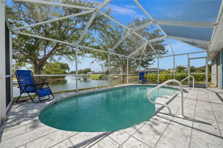 Outdoor pool featuring a lanai, a sunroom, a patio area, and a water view