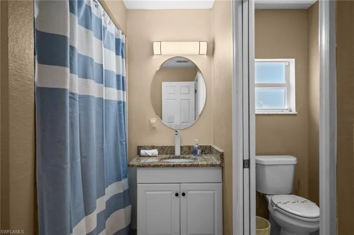 Full bathroom with vanity and a shower with curtain