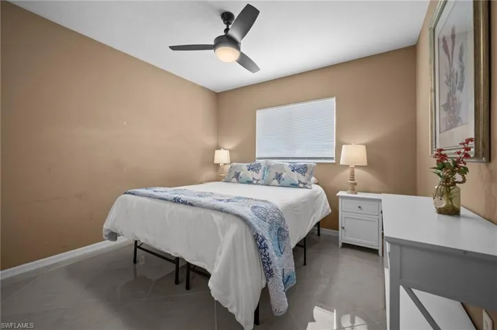 Bedroom with baseboards and a ceiling fan