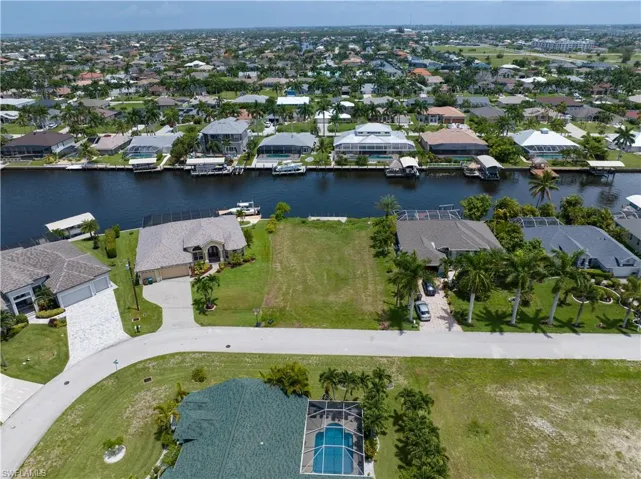Birds eye view of property with a water view