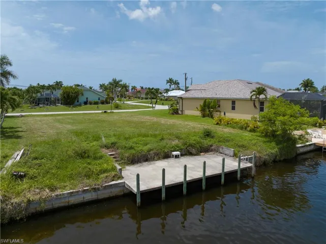 Dock area featuring a water view and a lawn