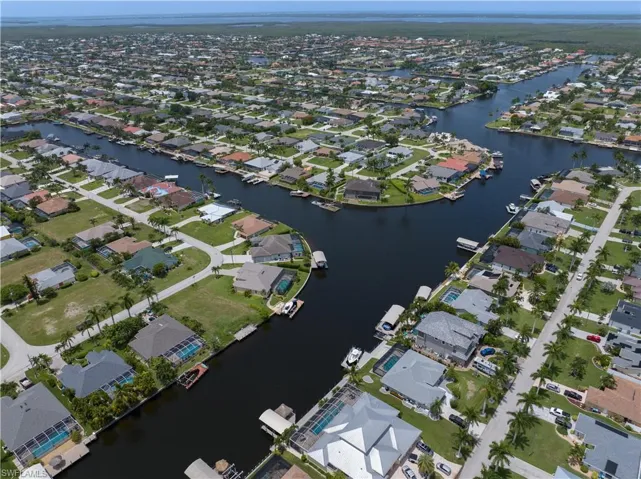 Birds eye view of property with a water view