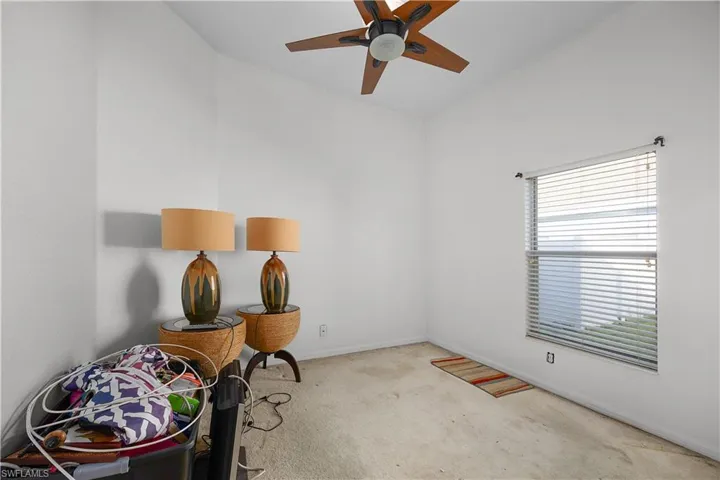 Misc room with carpet flooring and ceiling fan