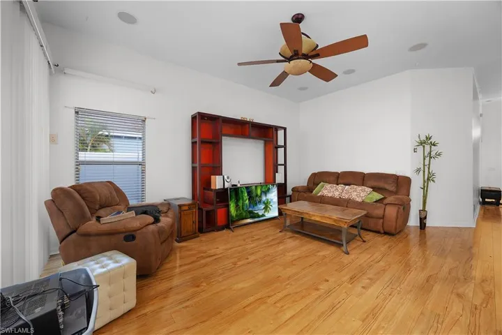 Living room featuring light wood-style floors and a ceiling fan