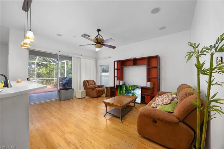 Living room with light wood-style floors and a ceiling fan