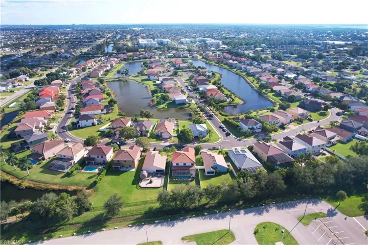 Aerial view of property's location with a large body of water