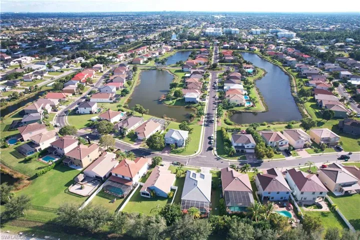 Aerial view of property's location with a large body of water