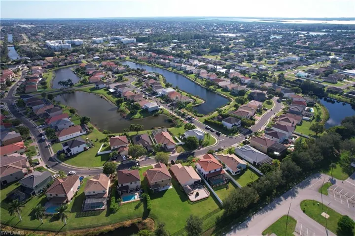 Aerial view of property's location with a large body of water