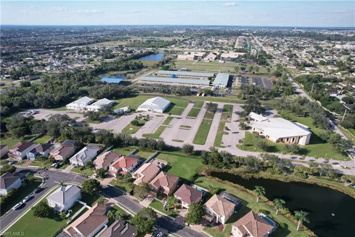 Aerial view of property's location featuring a large body of water and nearby suburban area