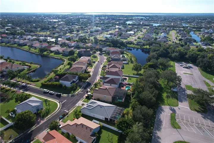Aerial overview of property's location with a nearby body of water and nearby suburban area