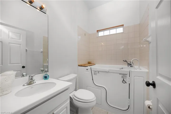 Full bath with a garden tub and vanity
