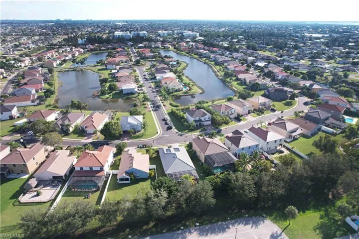 View of property location with a nearby body of water and nearby suburban area
