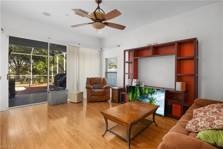 Living area with wood finished floors and ceiling fan