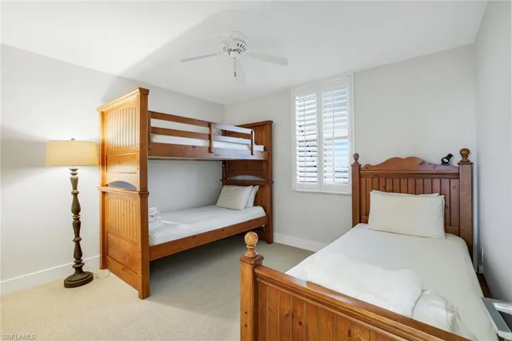 Bedroom featuring light carpet and ceiling fan