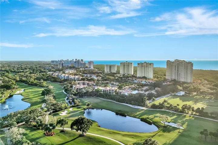 View of Club Pelican Bay golf course and high rise condominium and the Gulf