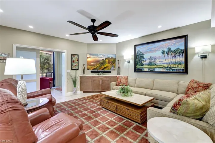 Relax in one of these leather chairs as part of the furnishings for this Pelican Bay gem