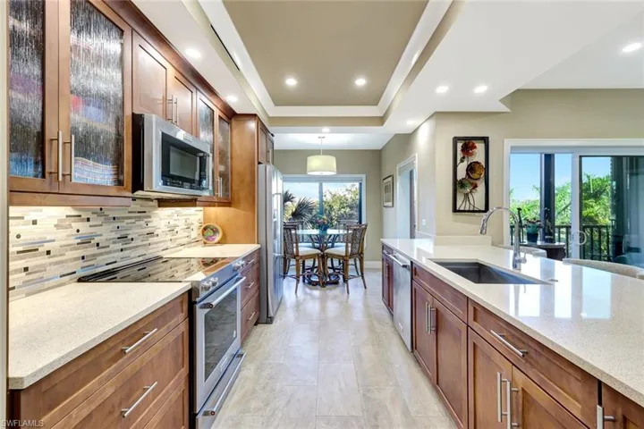Updatd kitchen with designer tile , upscale appliances and quartz countertops