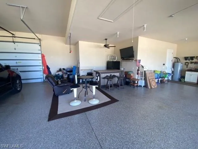 Garage featuring ceiling fan and water heater
