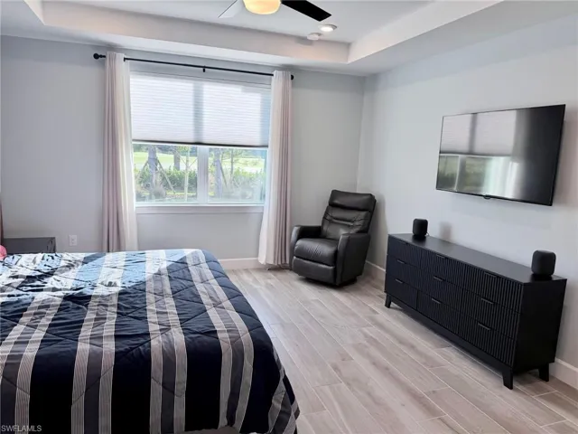 Master bedroom featuring tray ceiling