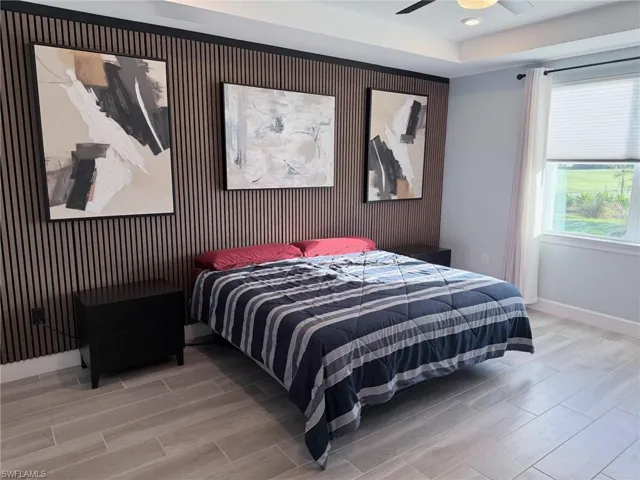 Master bedroom featuring tray ceiling
