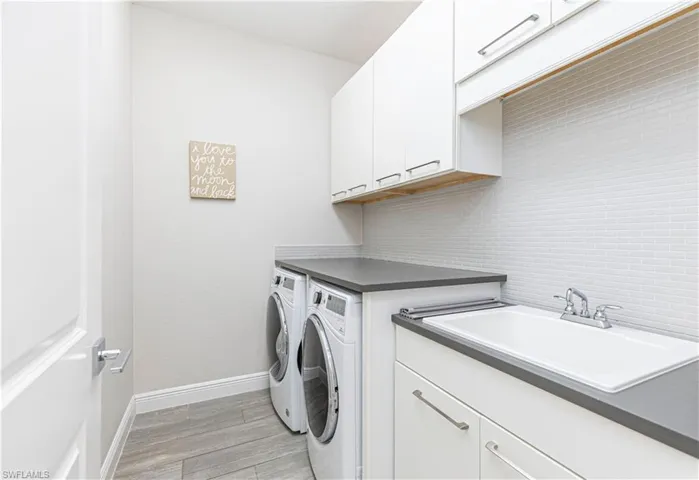 Laundry Room with front load washer & dryer and utlity sink