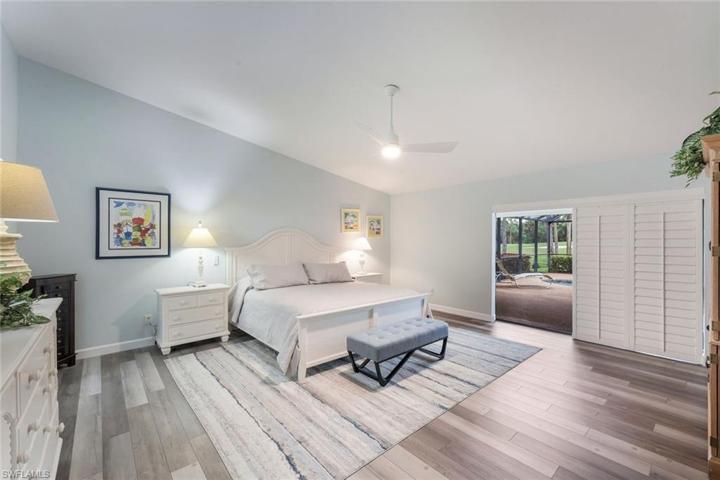 Primary Bedroom Suite, Shown with a King Bed (19' x 18'), Volume Ceilings, Triple Sliders to Covered Lanai, Walk In Closet Room 9' x 8' and a Separate Linen Closet