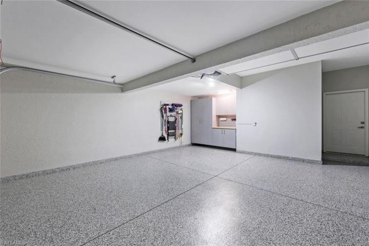 A dreamy organized garage with epoxy floors and great custom storage!