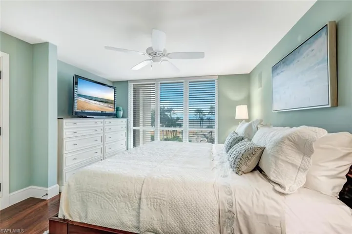 Bedroom with dark wood-type flooring and ceiling fan