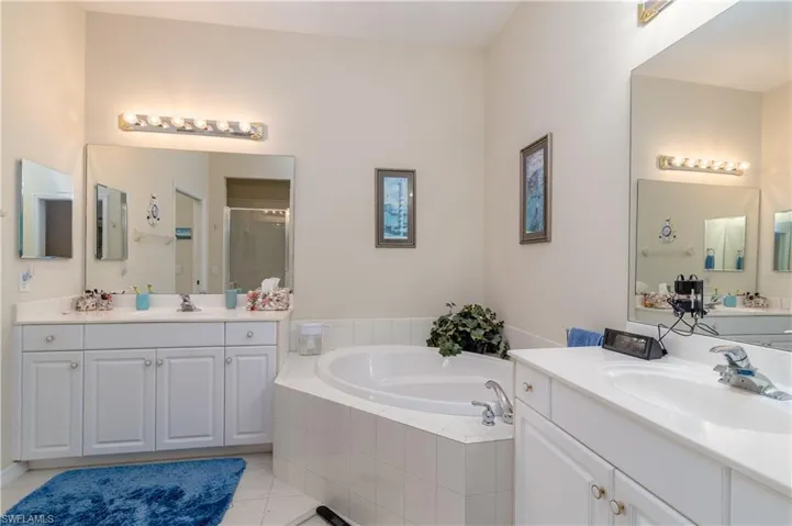 Bathroom with independent shower and bath, vanity, and tile patterned floors