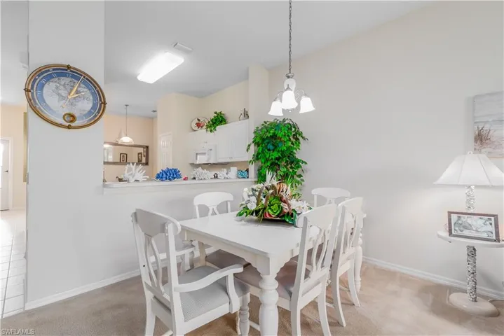 Dining space featuring a chandelier and light colored carpet