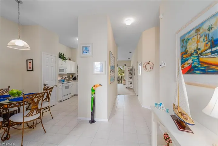 Corridor featuring light tile patterned floors