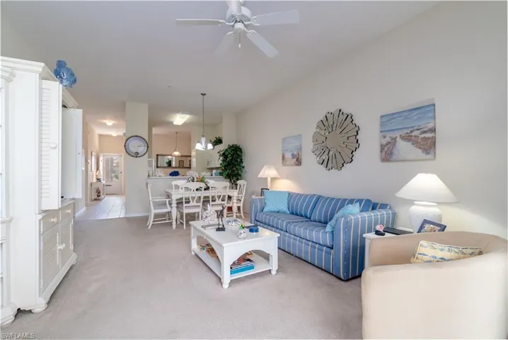 Living room with light carpet and ceiling fan