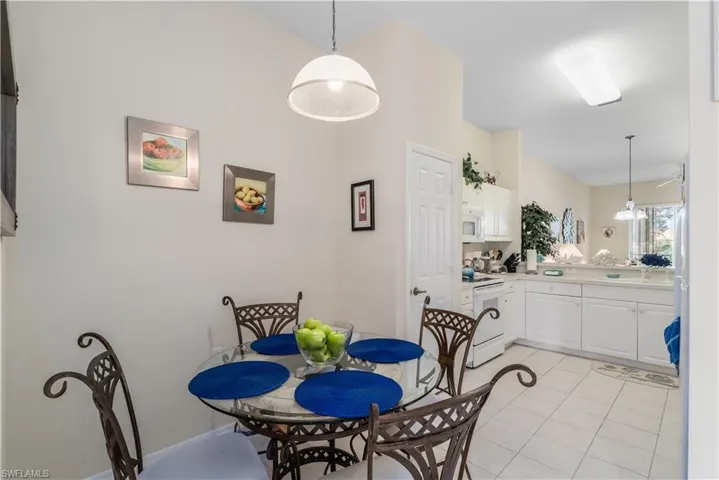 Dining space with light tile patterned floors and sink