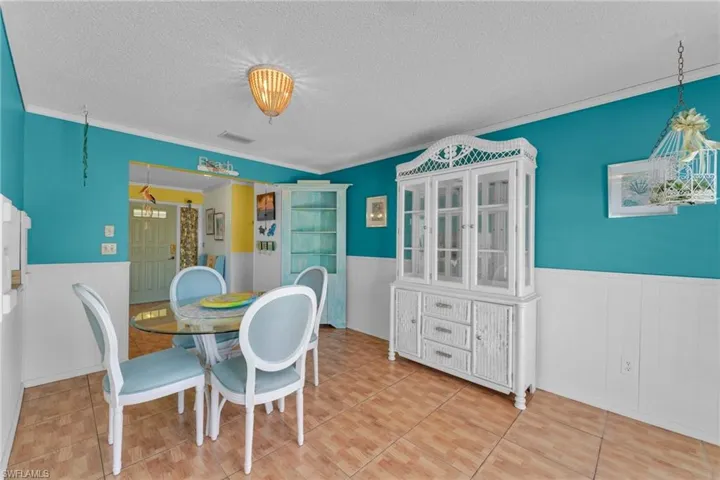 Dining area featuring ornamental molding and a textured ceiling