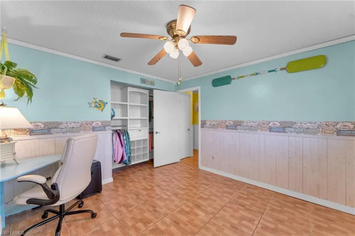 Office featuring crown molding, ceiling fan, and a textured ceiling