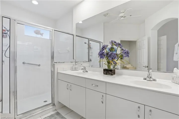 Bathroom vanity with dual undermount sinks, chrome fixtures, and ample countertop space