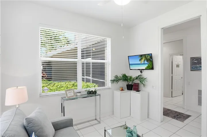 Bright interior space featuring white walls and square tile flooring