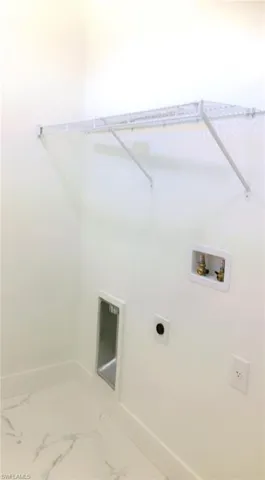 Clothes washing area featuring electric dryer hookup and washer hookup