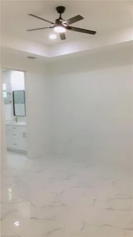 Master bedroom featuring tile patterned floors and ceiling fan