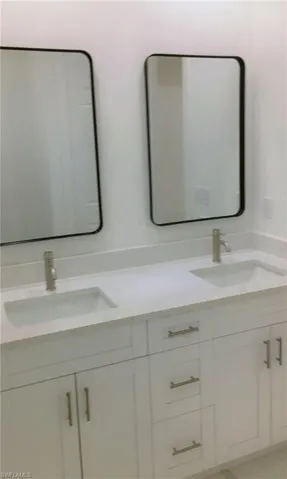 Bathroom featuring dual bowl vanity
