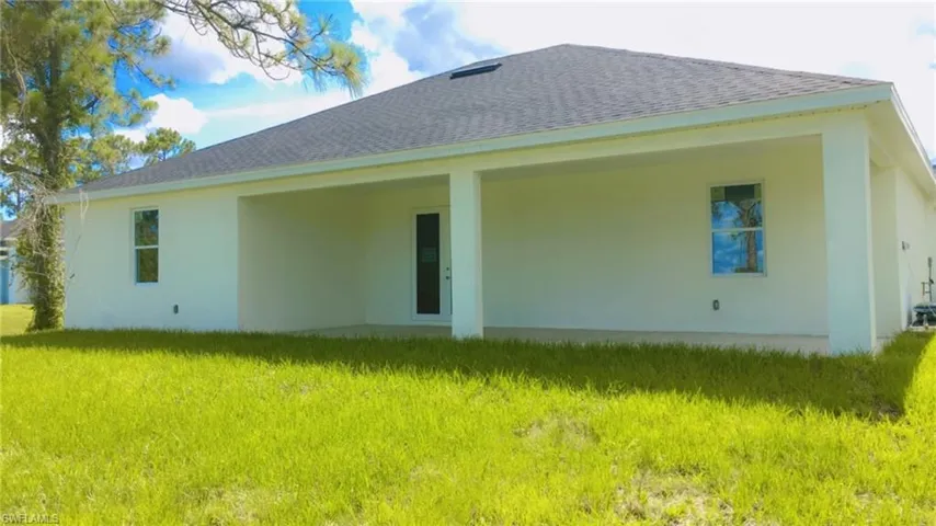 Back of property with a yard