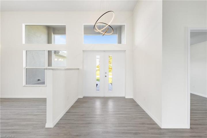 high ceiling entry with designer lighting