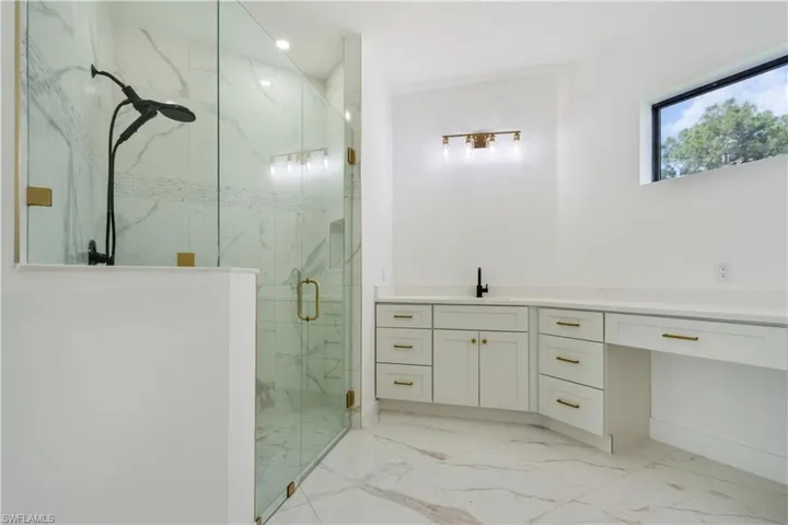 Full bath with a marble finish shower, marble finish floors, vanity, and recessed lighting