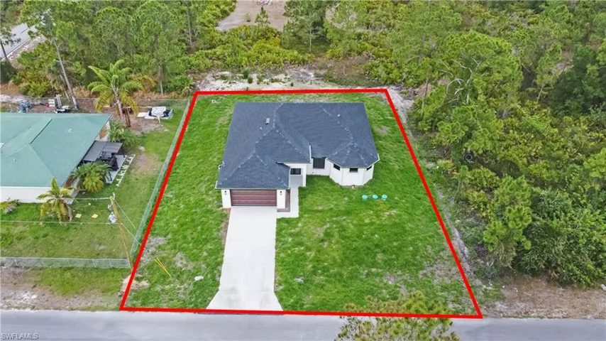 Aerial view of property and surrounding area with property parcel outlined