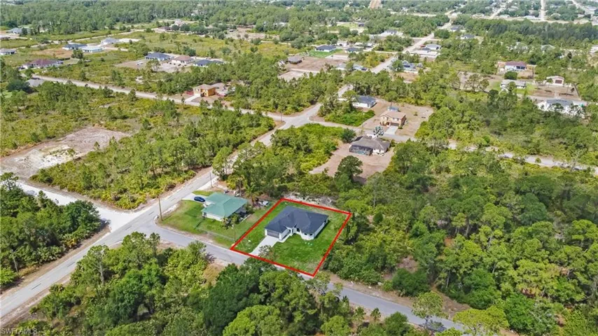 Aerial perspective of suburban area featuring property boundaries highlighted