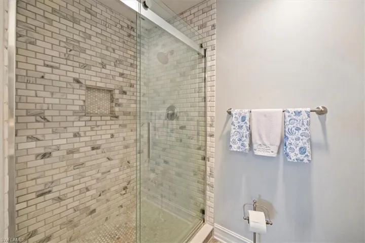 Full bath featuring a shower stall